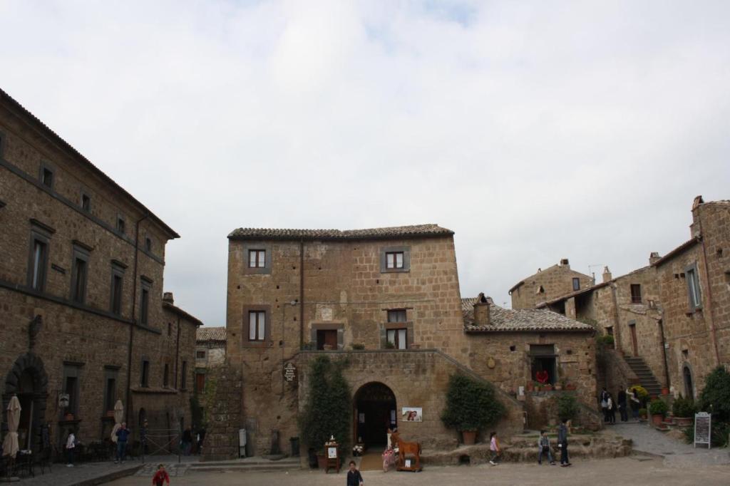 a group of stone buildings in a courtyard at Locanda Della Buona Ventura in Bagnoregio