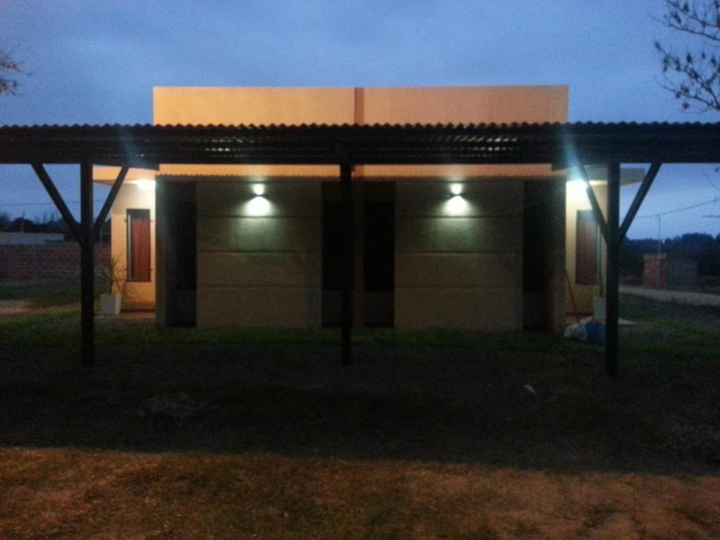a building with lights in front of it at night at Bungalows Don Heraldo in San José