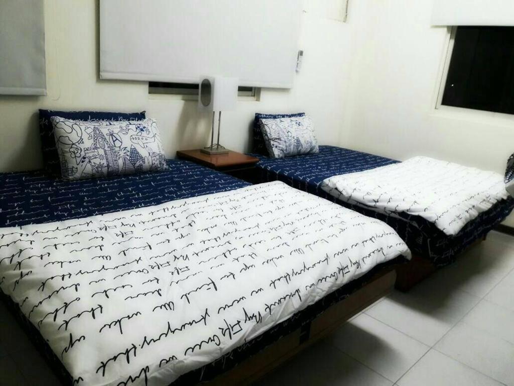 Postel nebo postele na pokoji v ubytování Hsianghua Guesthouse
