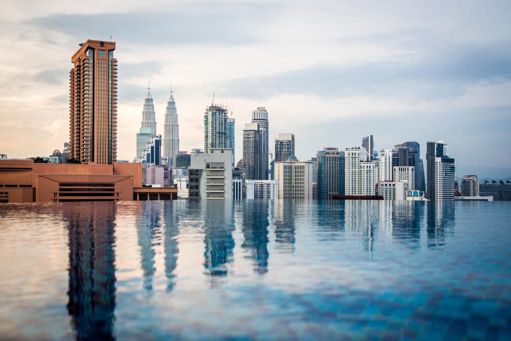 a view of a city skyline from a rooftop pool at D'Majestic Place by Widebed in Kuala Lumpur