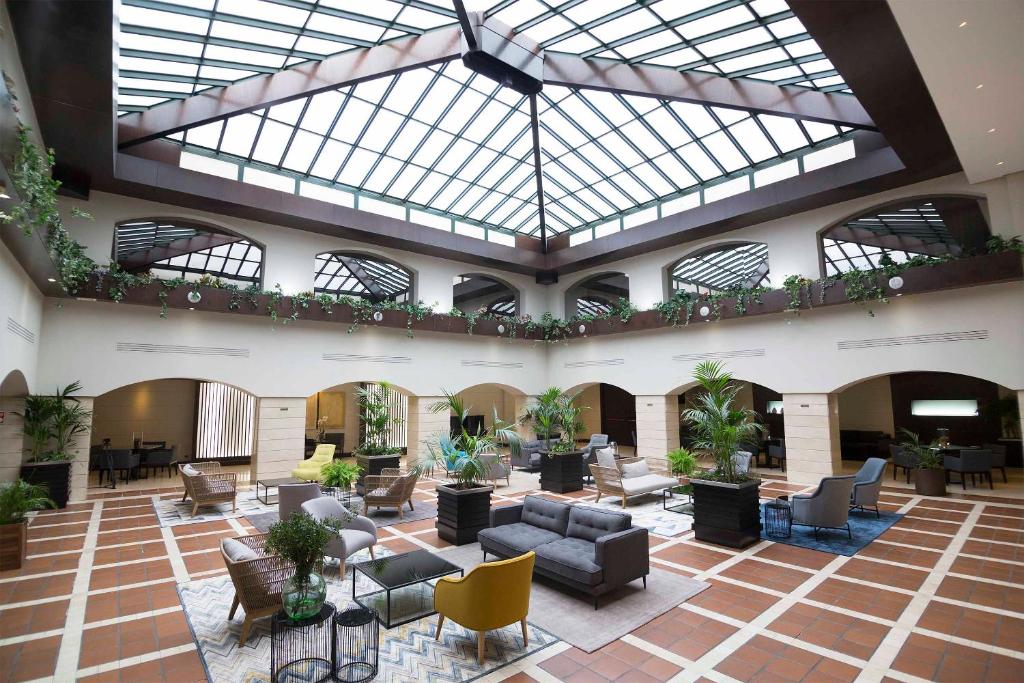 a large lobby with couches and chairs in a building at Intelier Rosa in Castellón de la Plana