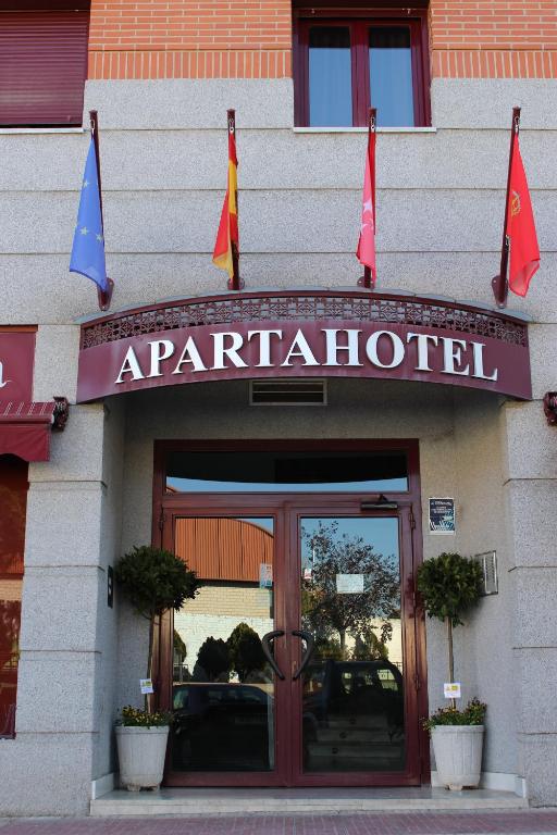 a entrance to a restaurant with flags in front of it at Apartahotel Villa de Parla in Parla