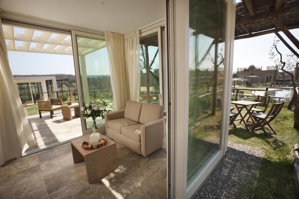 a living room with a couch and sliding glass doors at Di Toscana Holidays in Cecina