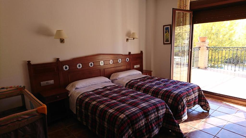 מיטה או מיטות בחדר ב-Hospedería Los Cahorros