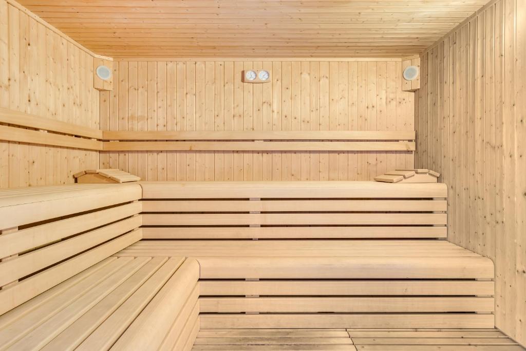 an empty wooden sauna with wooden floors and ceilings at Hotel Ambassador in Caorle