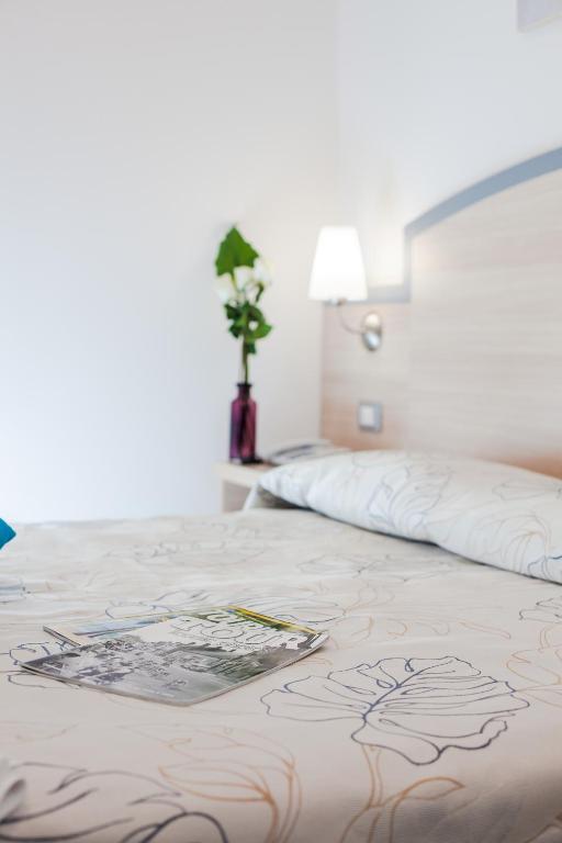 Postel nebo postele na pokoji v ubytování Hotel Beau Soleil