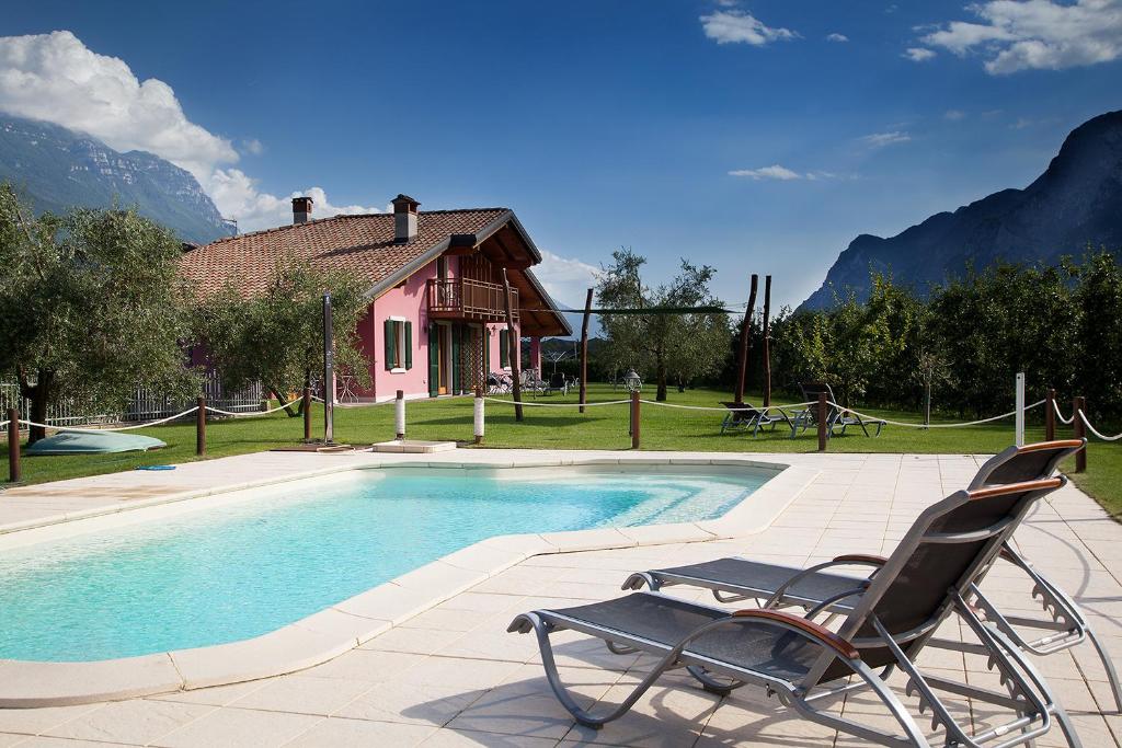 a chair sitting next to a swimming pool at Agritur La Cort in Arco