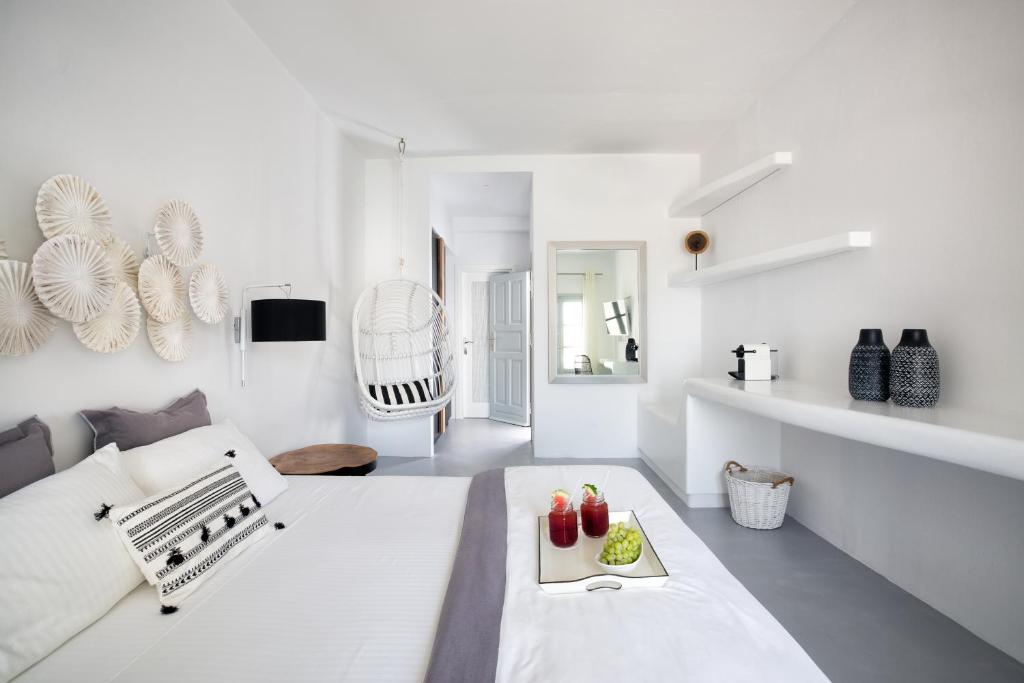 a white living room with a white couch at Blue Sand Boutique Hotel & Suites in Agali