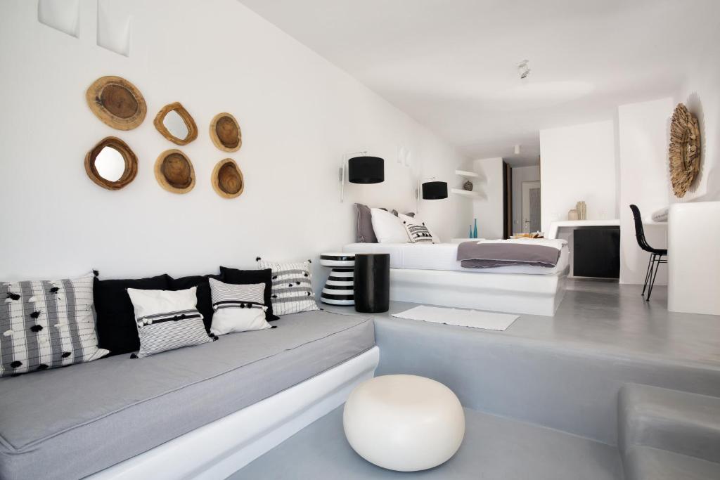 a white room with two beds and a couch at Blue Sand Boutique Hotel & Suites in Agali