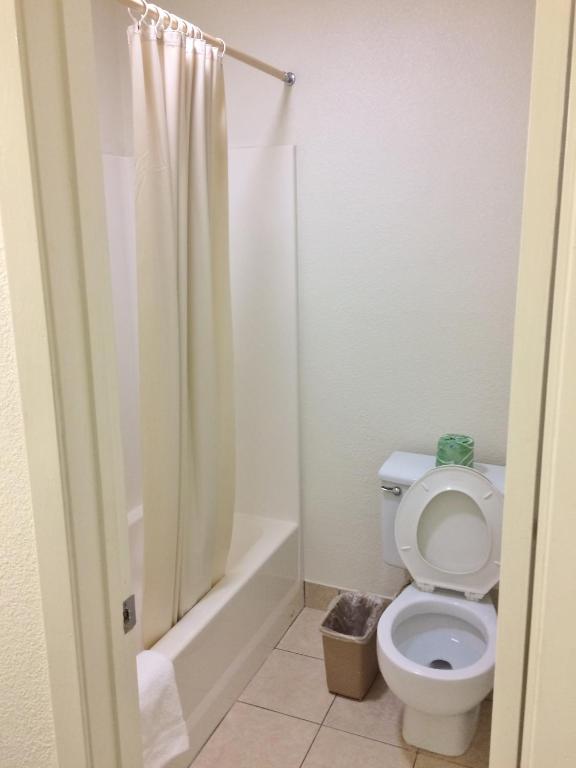 a bathroom with a toilet and a shower at Travel Inn & Suites in Atlanta