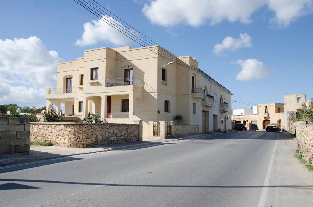 a large white house on the side of a street at South Olives in Żejtun