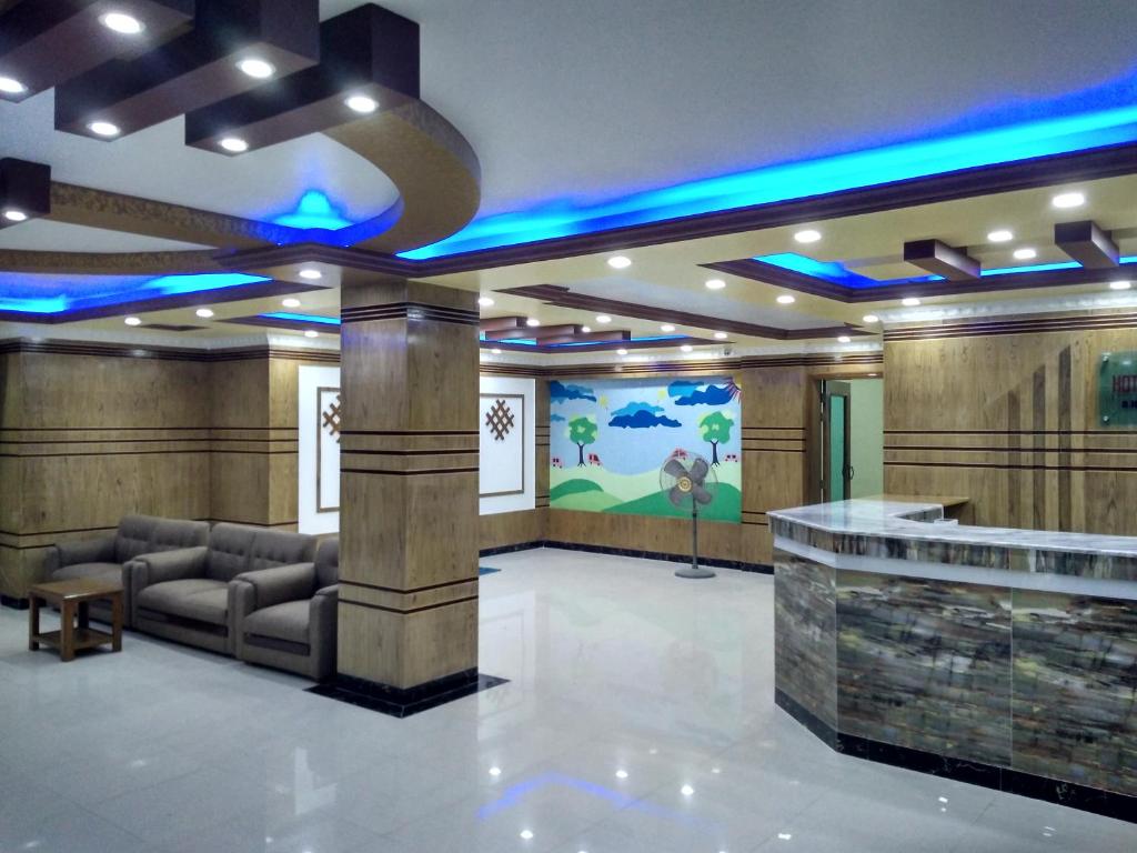 a lobby with a waiting room with blue lights at Hotel Quality Home in Cox's Bazar