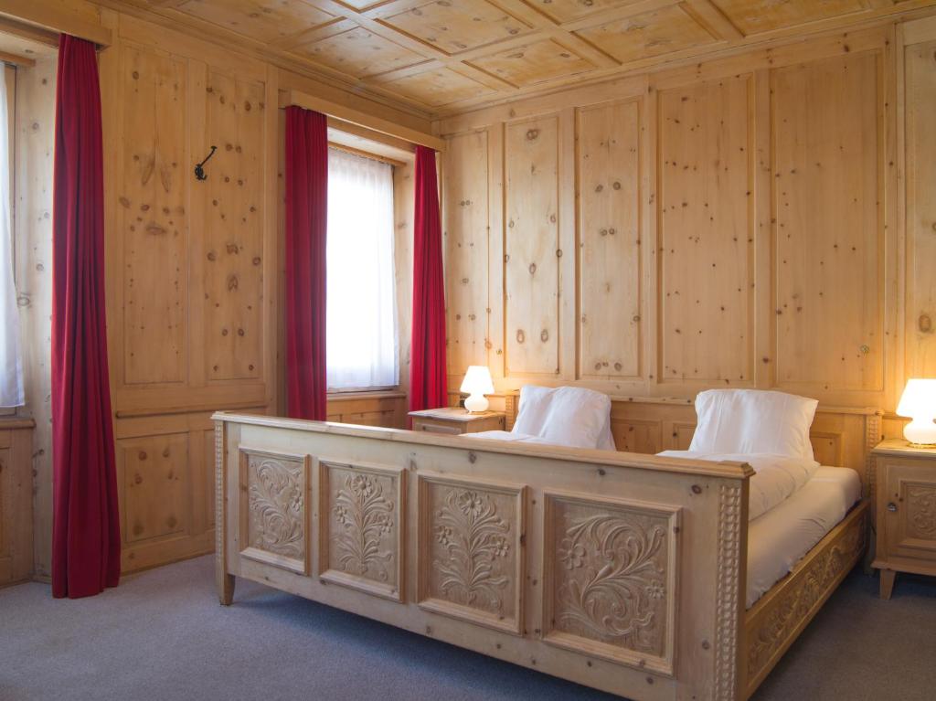 Postel nebo postele na pokoji v ubytování Hotel Alpina