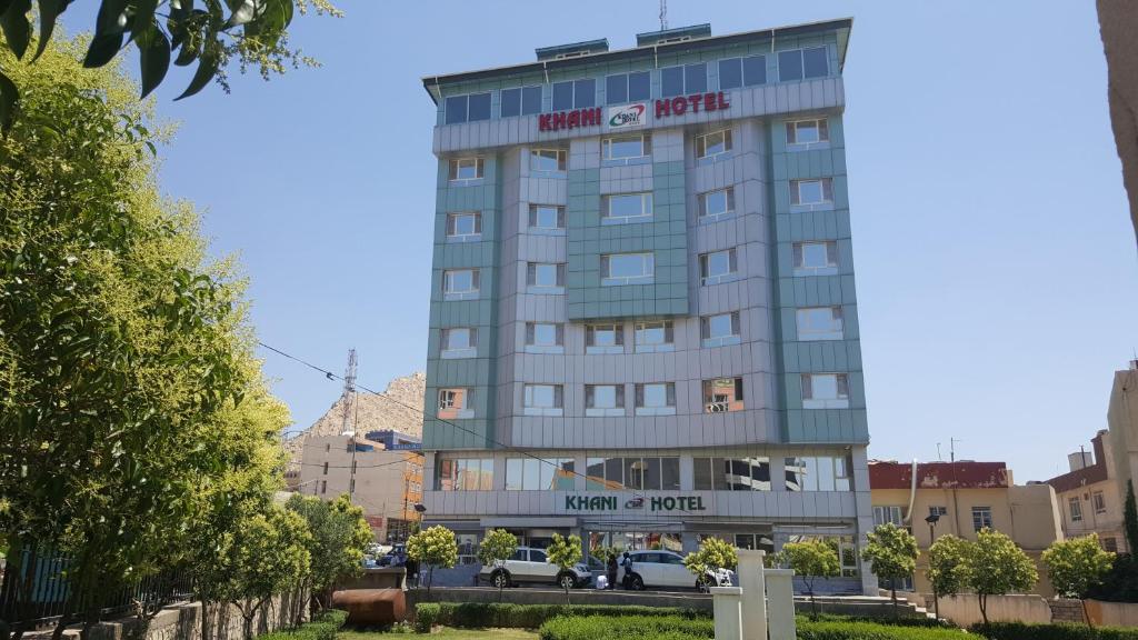 a building with a sign on the front of it at Khani Hotel in Duhok