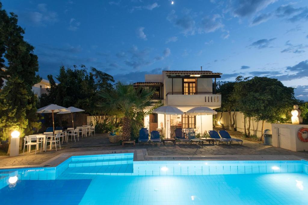 Villa con piscina por la noche en Proimos Maisonnettes, en Plataniás