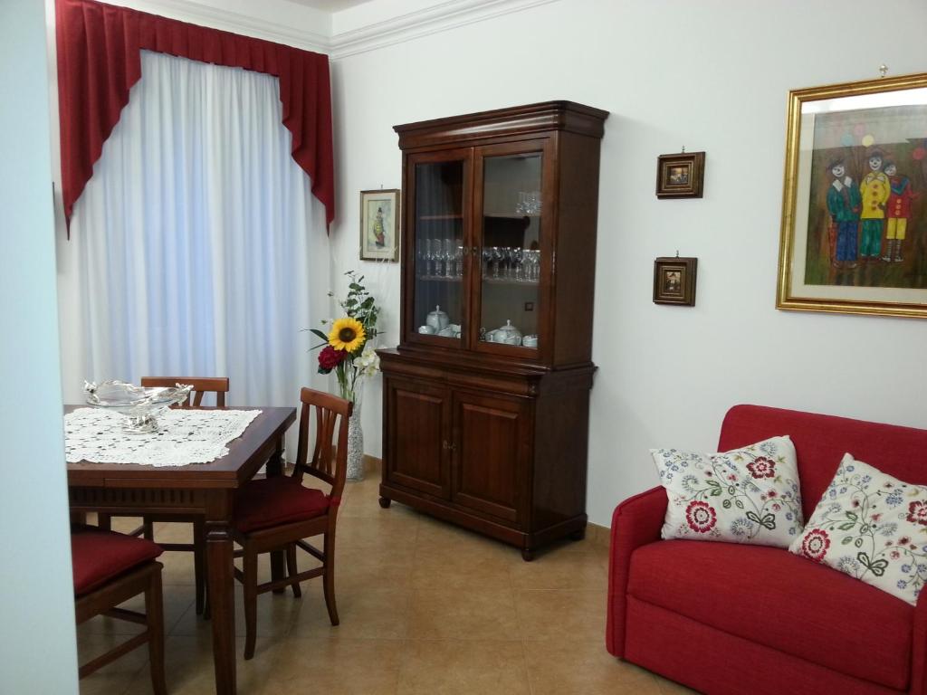 a living room with a dining table and a cabinet at CHEZ-ROBY in Rome