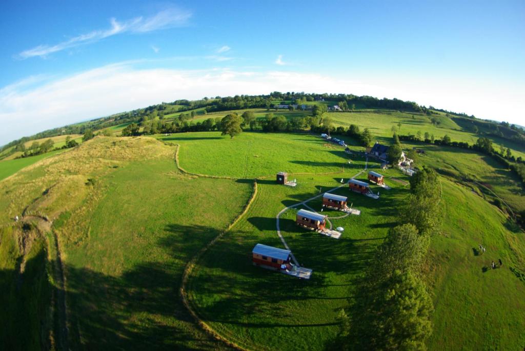 an aerial view of a field with many trucks at Domaine de la Chaux de Revel in Saint-Martin-Valmeroux