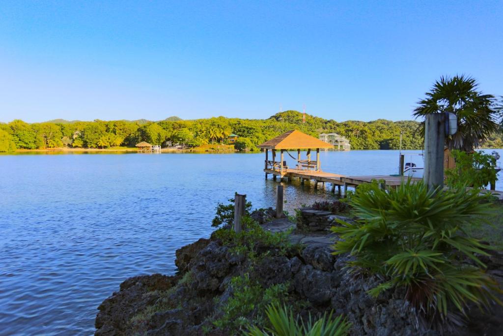 a dock with a gazebo in the middle of a lake at Hotel Posada Las Orquídeas in West End