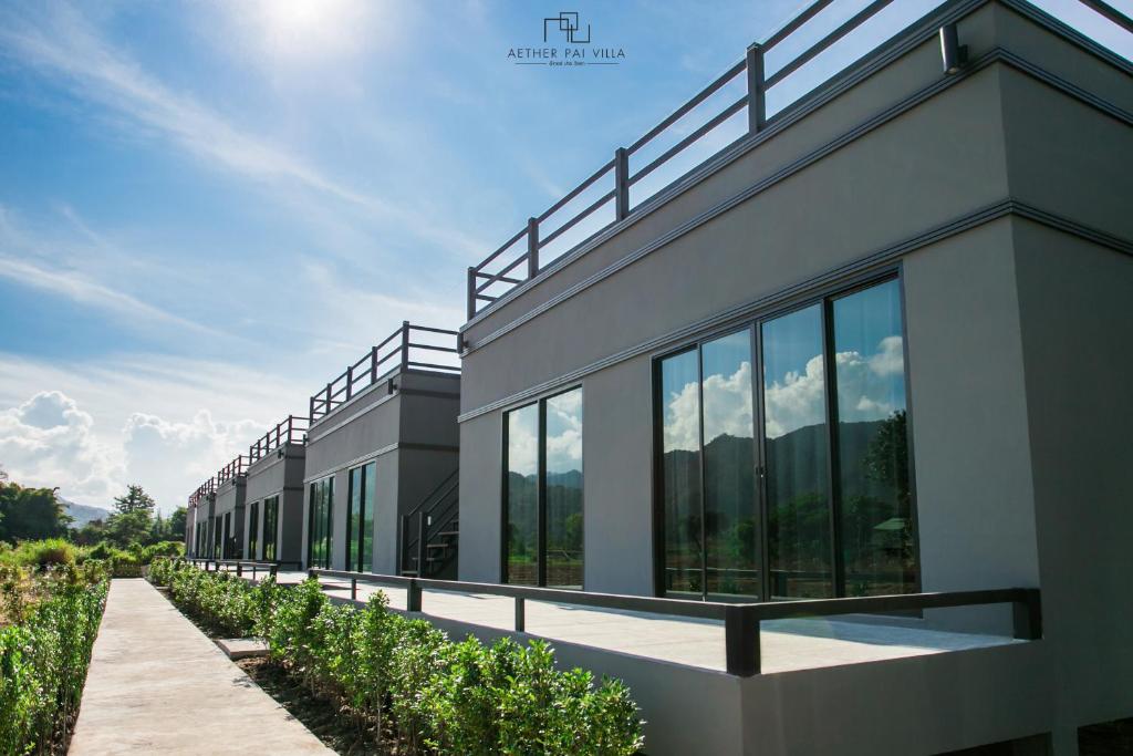 a building with glass windows on the side of it at Aether Pai Villa in Pai