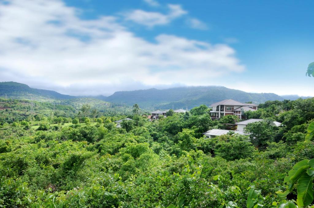 a view of a forest with mountains in the background at Forest Escapes Koyna in Koynanagar