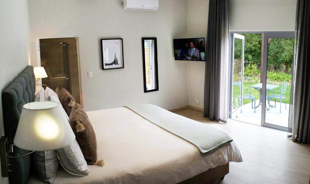 Postel nebo postele na pokoji v ubytování Vine Guesthouse