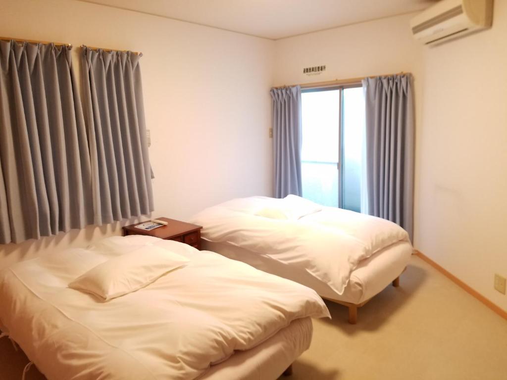 Postel nebo postele na pokoji v ubytování Villa M Guesthouse