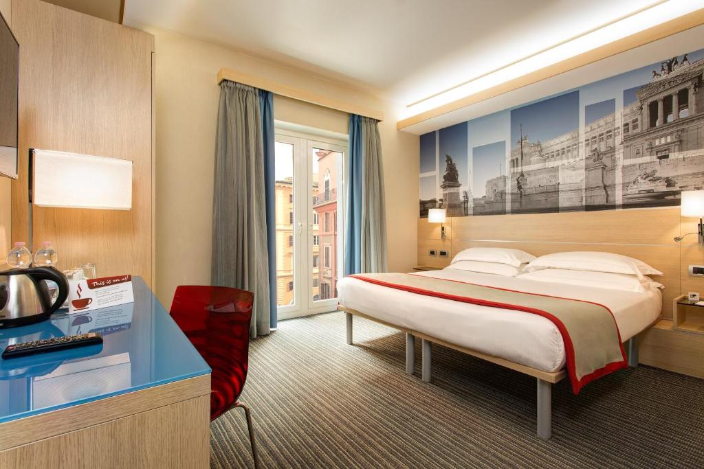 Postel nebo postele na pokoji v ubytování iQ Hotel Roma