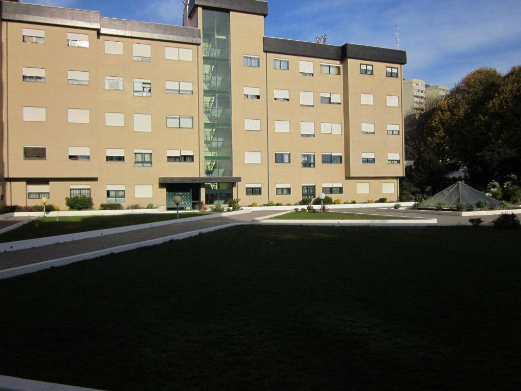a large building with a large lawn in front of it at Comfortable & central apartment in Senhora da Hora
