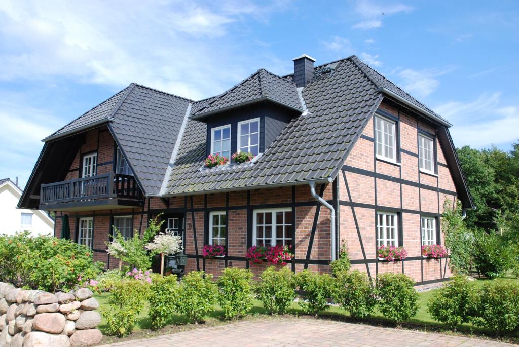 a large house with a black roof at Haus Gode Tied - Apt. 01 in Ostseebad Sellin