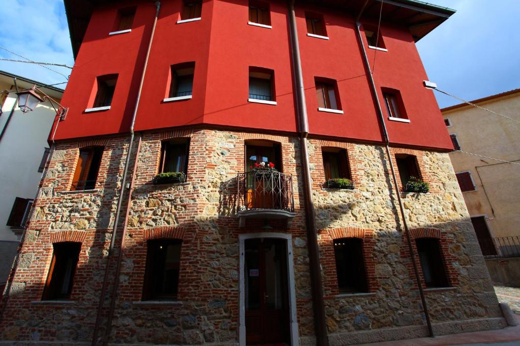 a red building with a balcony on top of it at B&B da Toi in Marostica
