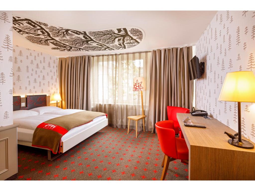 A bed or beds in a room at Swiss Night by Fassbind