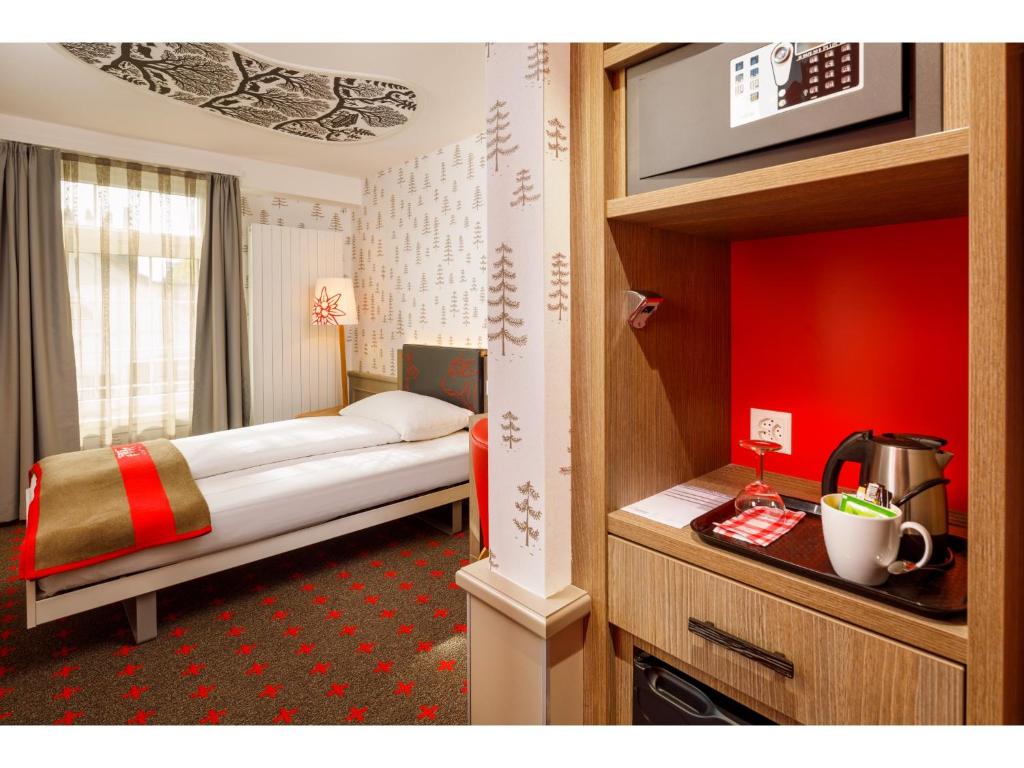 A bed or beds in a room at Swiss Night by Fassbind