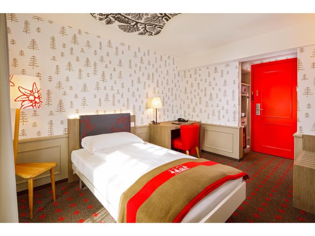 A bed or beds in a room at Swiss Night by Fassbind
