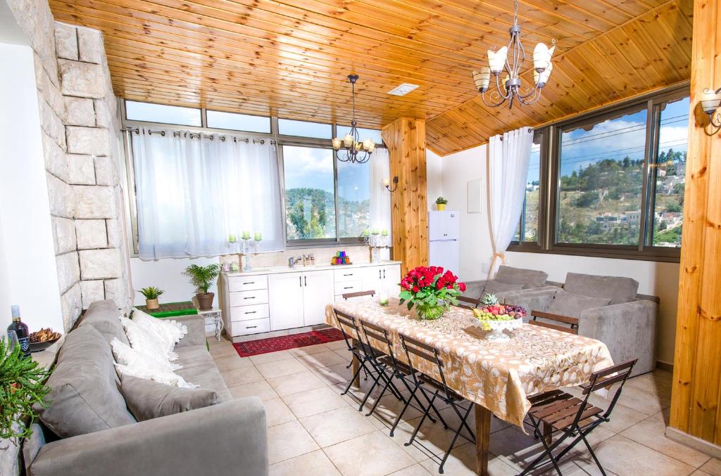 a living room with a table and a couch at The Spirit Of Tzfat Villa in Safed