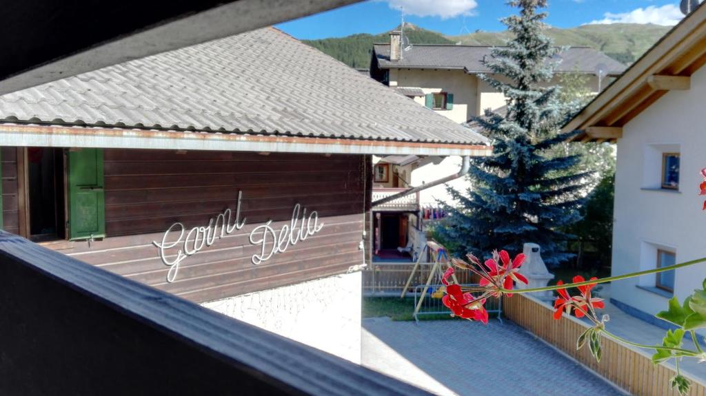 a house with a christmas tree on a balcony at Garni Delia in Livigno