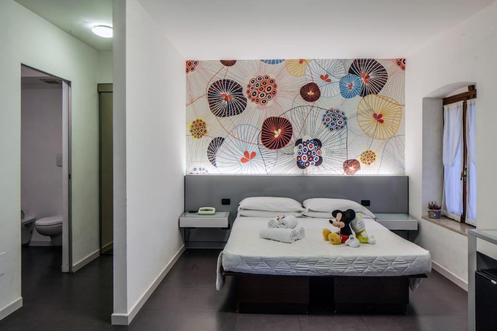 Postel nebo postele na pokoji v ubytování Hotel Gattopardo