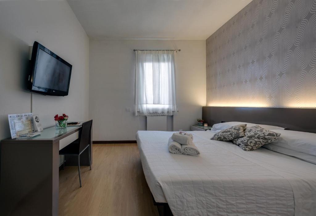 Postel nebo postele na pokoji v ubytování Hotel Gattopardo