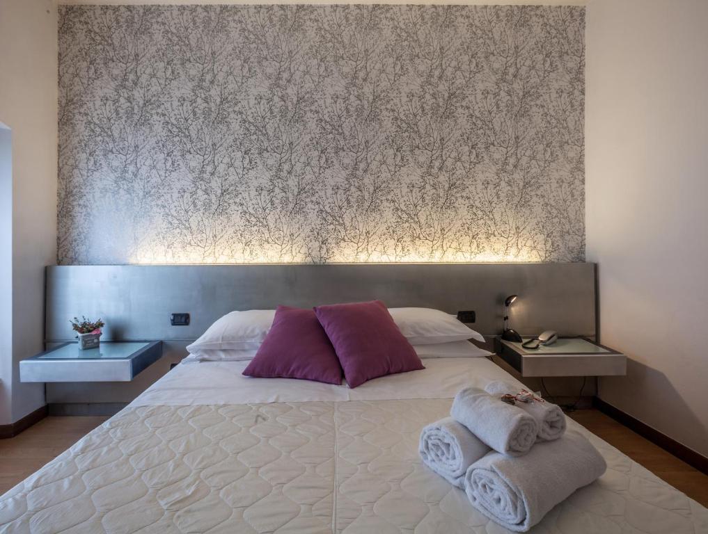 Postel nebo postele na pokoji v ubytování Hotel Gattopardo