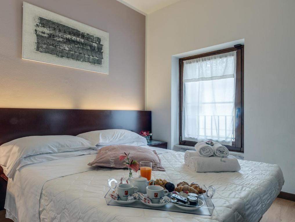 Postel nebo postele na pokoji v ubytování Hotel Gattopardo