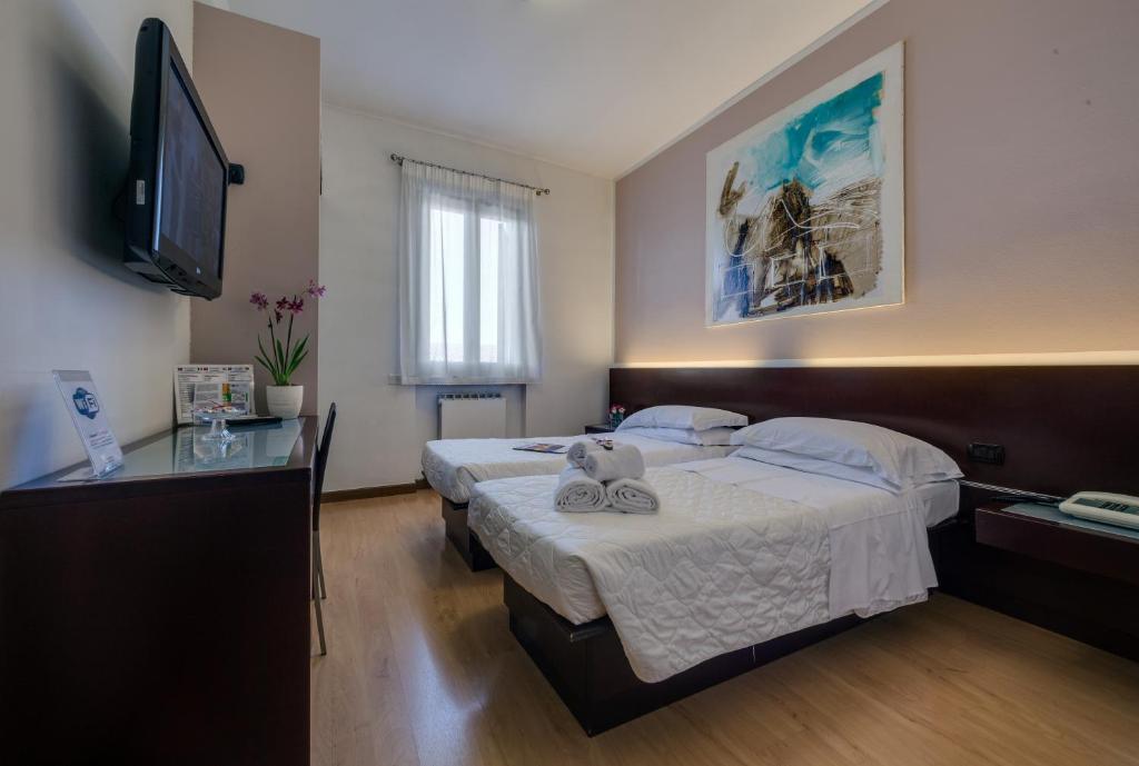 Postel nebo postele na pokoji v ubytování Hotel Gattopardo