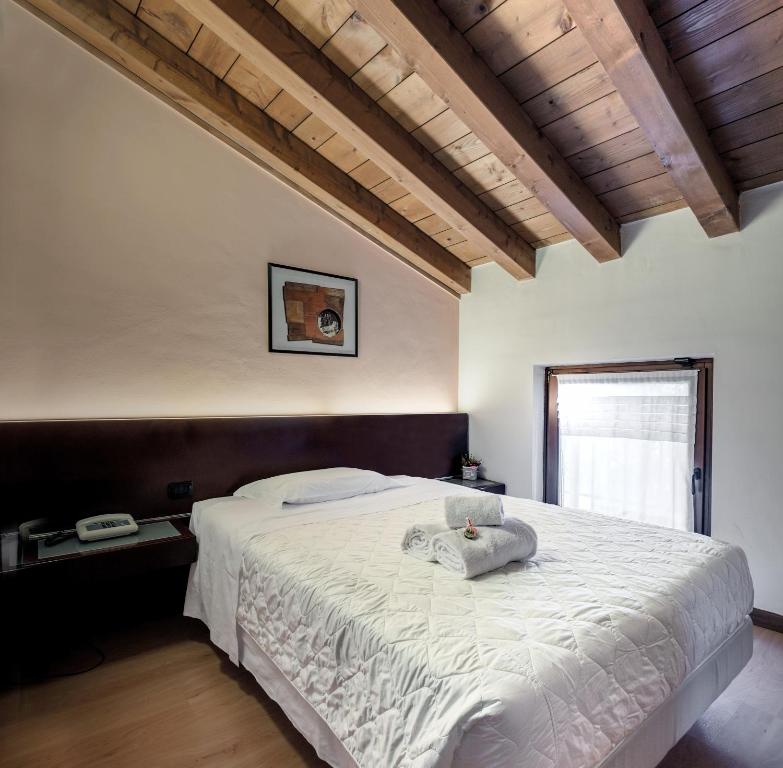 Postel nebo postele na pokoji v ubytování Hotel Gattopardo