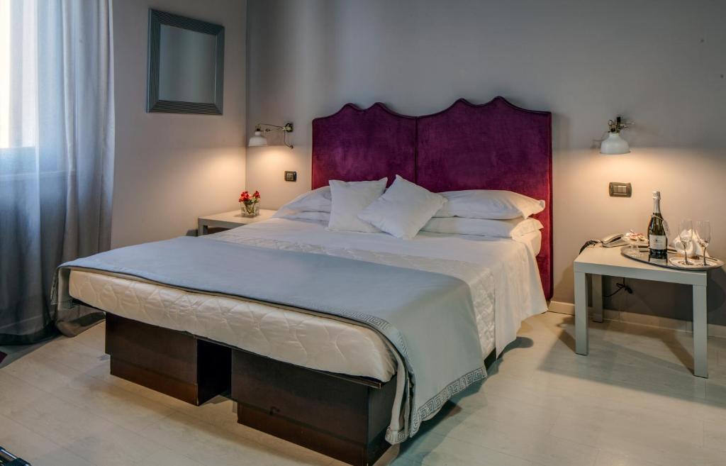 Postel nebo postele na pokoji v ubytování Hotel Gattopardo