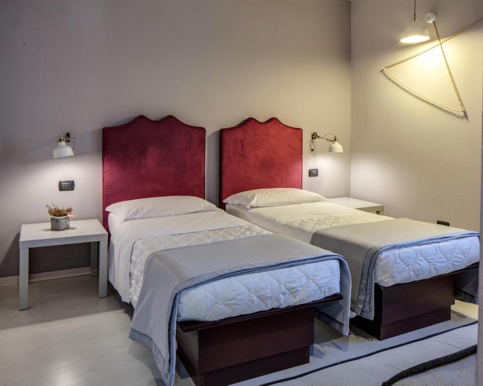 Postel nebo postele na pokoji v ubytování Hotel Gattopardo