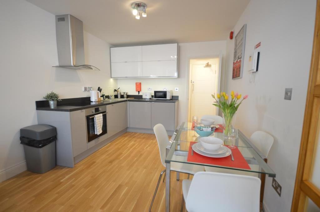 a kitchen and dining room with a table and chairs at 3A Soho Studios 3rd floor by Indigo Flats in London