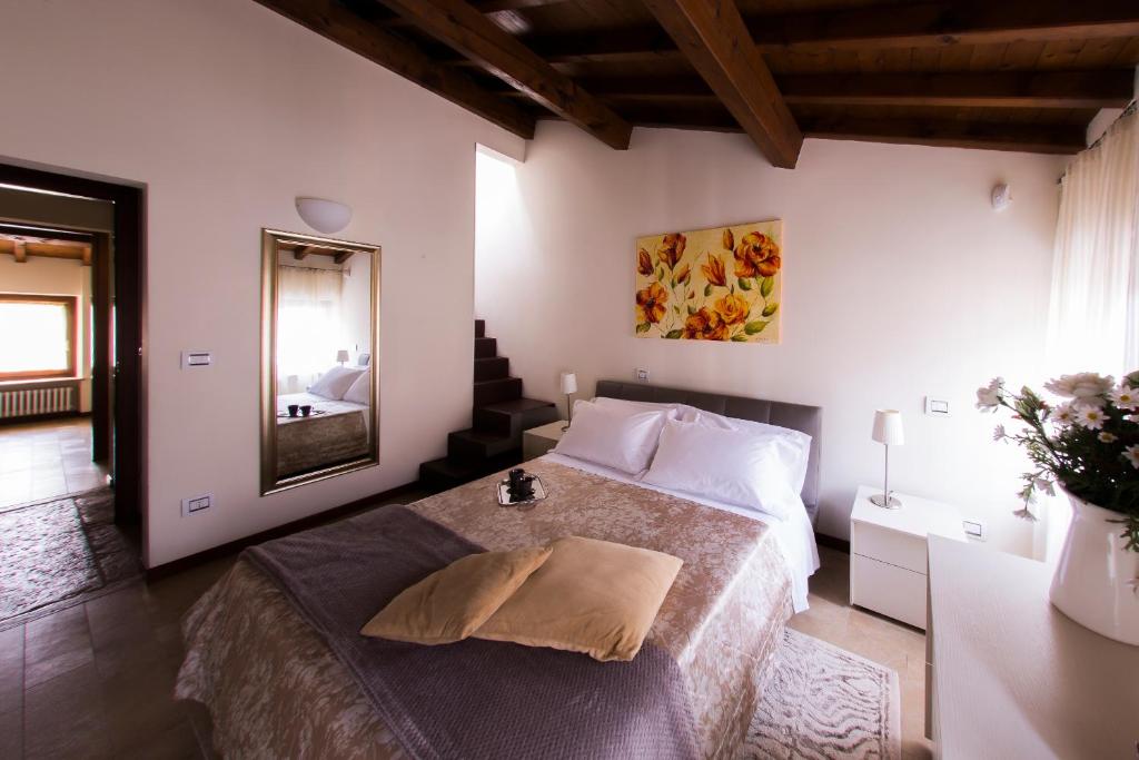 a bedroom with a bed and a mirror in it at Arena Dreams Apartment in Verona