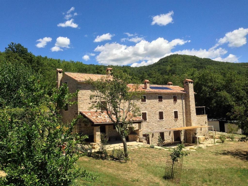 a large stone building with a mountain in the background at Bolara 60: the Cottage in Grožnjan