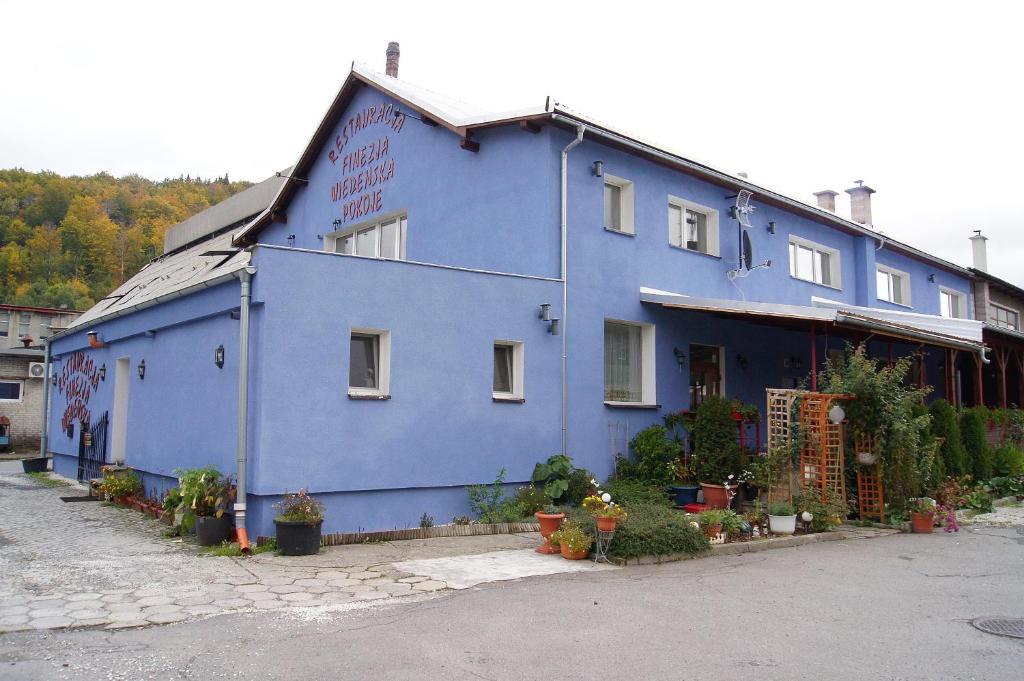 a blue building with plants in front of it at Finezja Wiedeńska in Stronie Śląskie