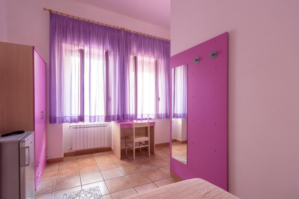 Postel nebo postele na pokoji v ubytování B&B Rose Villa