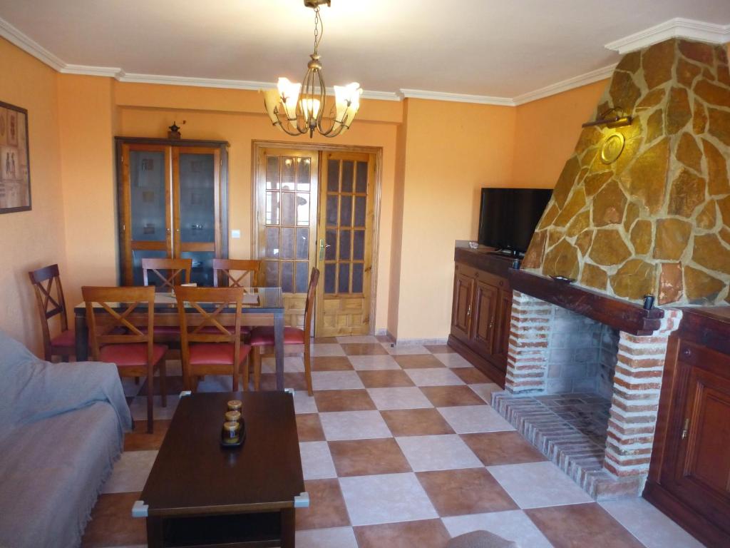 a living room with a couch and a fireplace at Casa Limas in La Iruela