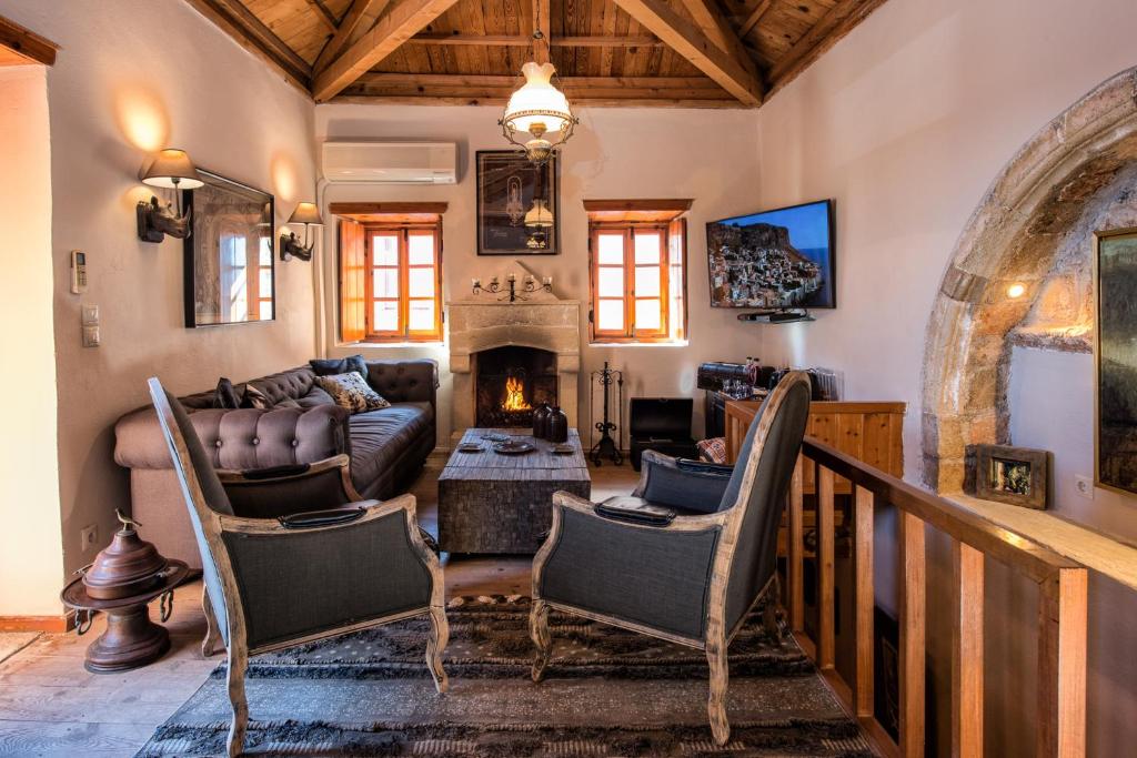 a living room with a couch and a fireplace at CASA FELICIA-The Castle Mansion in Monemvasia